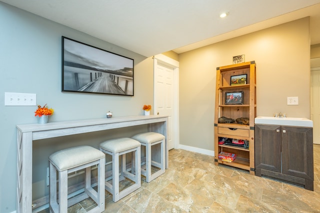 bar featuring dark brown cabinetry and sink