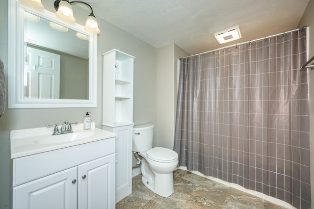 bathroom with walk in shower, vanity, a textured ceiling, and toilet