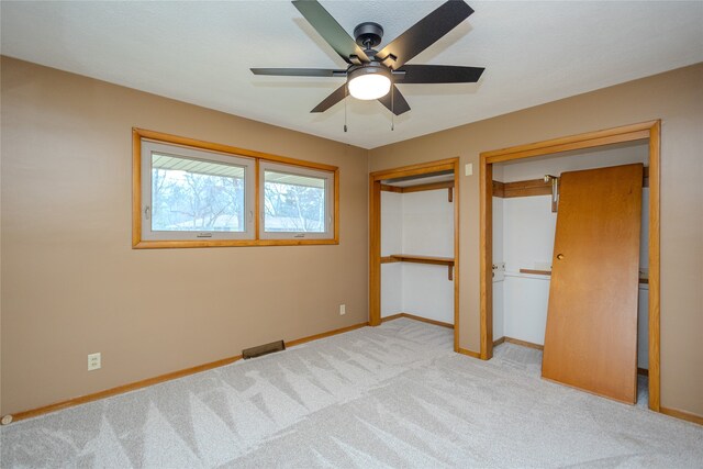 unfurnished bedroom featuring light carpet and ceiling fan