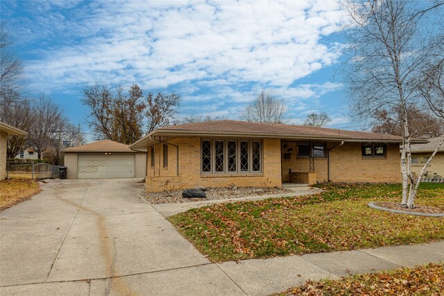 ranch-style home with an outbuilding, a garage, and a front yard