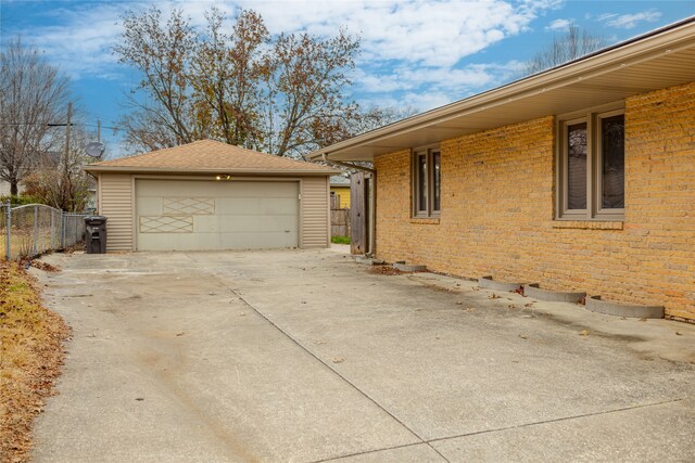 view of side of home featuring an outbuilding and a garage