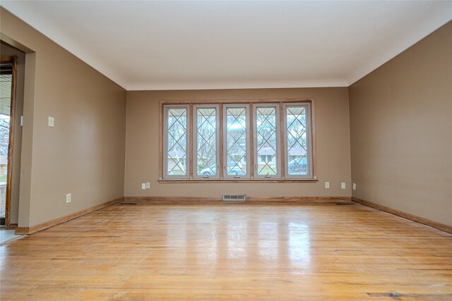 unfurnished room with plenty of natural light and light hardwood / wood-style floors