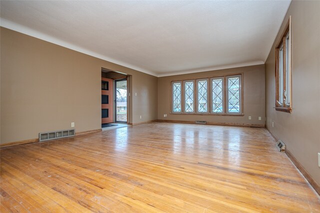 empty room with light hardwood / wood-style flooring