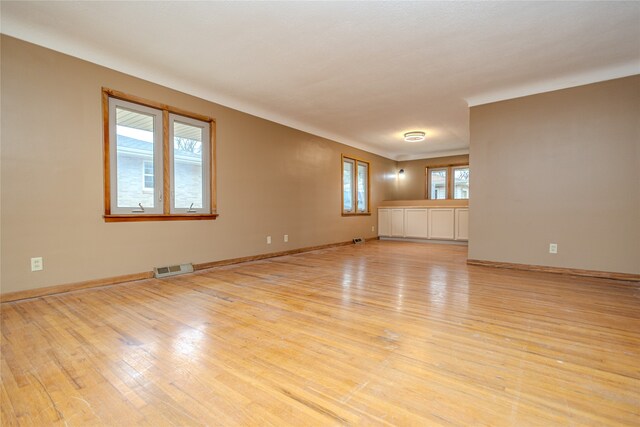 empty room with light hardwood / wood-style flooring