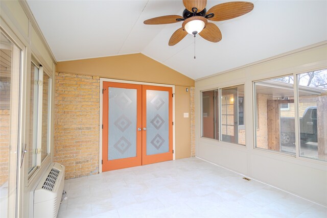 unfurnished sunroom featuring a wall unit AC, ceiling fan, french doors, and vaulted ceiling