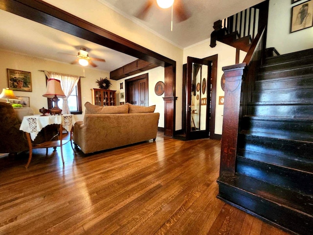 living room featuring wood-type flooring and ornamental molding