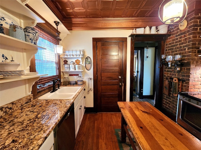 kitchen with dishwasher, dark wood-type flooring, white cabinets, sink, and hanging light fixtures