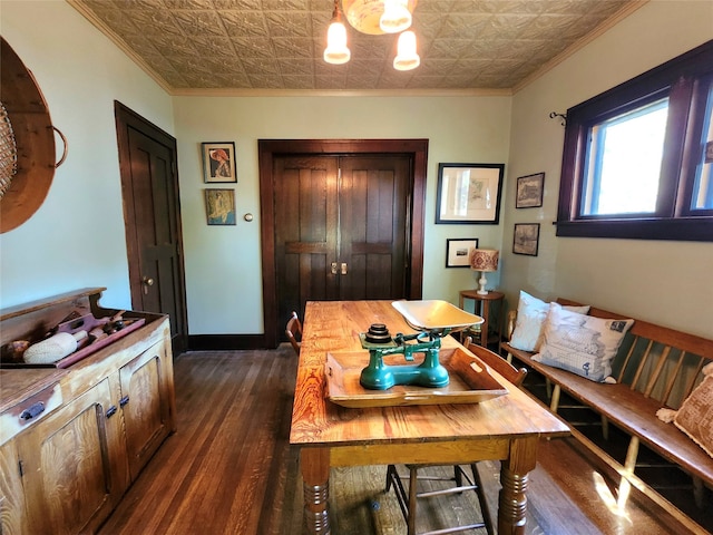 dining room with dark hardwood / wood-style floors and ornamental molding