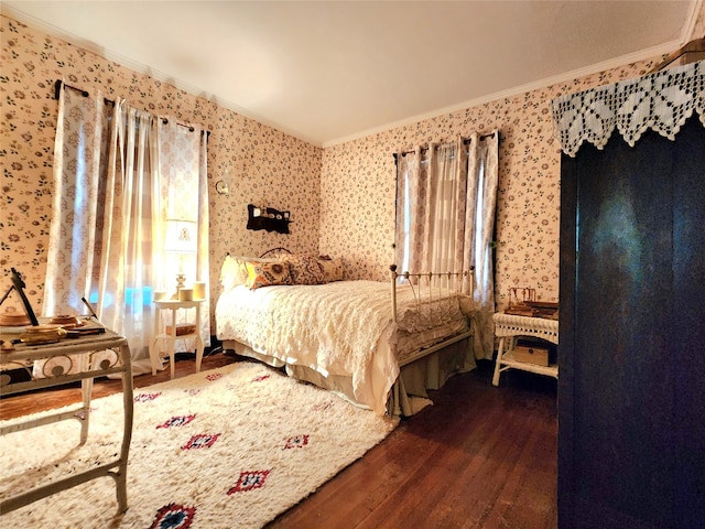 bedroom featuring crown molding and dark wood-type flooring