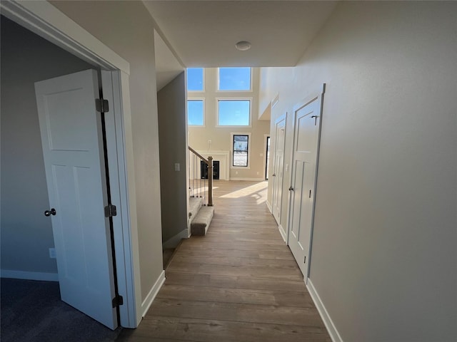 hallway with light hardwood / wood-style floors