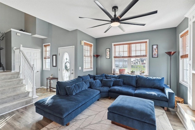 201 Elm Ave, Norwalk, IA 50211 - living room featuring light wood-style flooring, a ceiling fan, and stairs