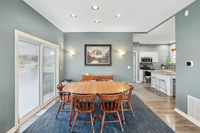 dining area with light hardwood / wood-style flooring