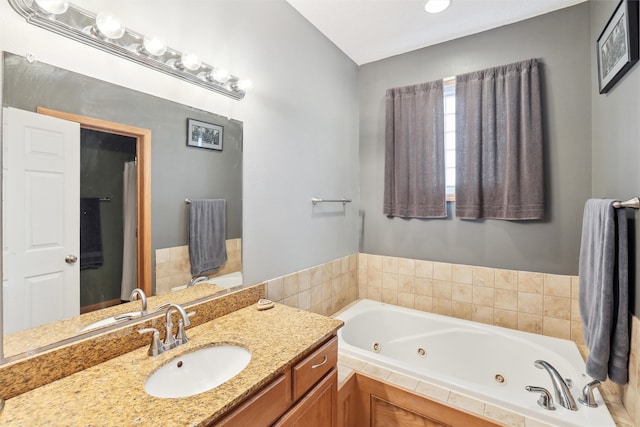 bathroom with vanity and a relaxing tiled tub