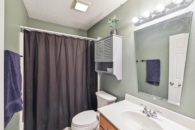 bathroom featuring vanity, toilet, and a textured ceiling