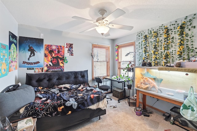 carpeted bedroom featuring ceiling fan and a textured ceiling