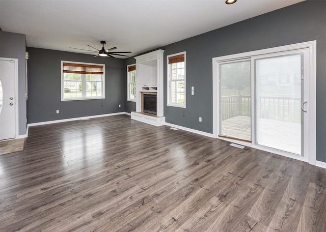 201 Elm Ave, Norwalk, IA 50211 - unfurnished living room with ceiling fan, dark wood-style floors, and a fireplace with raised hearth