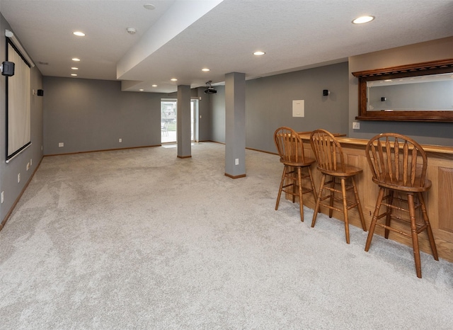 201 Elm Ave, Norwalk, IA 50211 - indoor dry bar featuring light colored carpet and recessed lighting