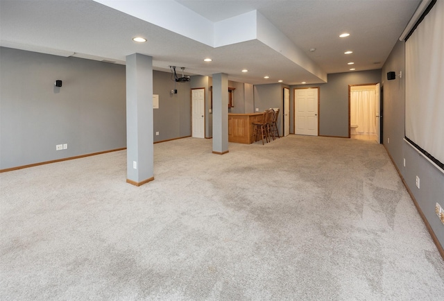 201 Elm Ave, Norwalk, IA 50211 - unfurnished living room featuring bar, recessed lighting, and carpet flooring