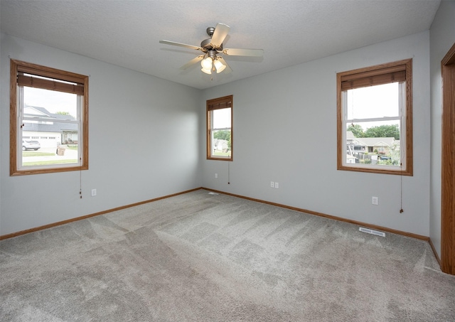 201 Elm Ave, Norwalk, IA 50211 - carpeted spare room with healthy amount of natural light, ceiling fan, and a textured ceiling