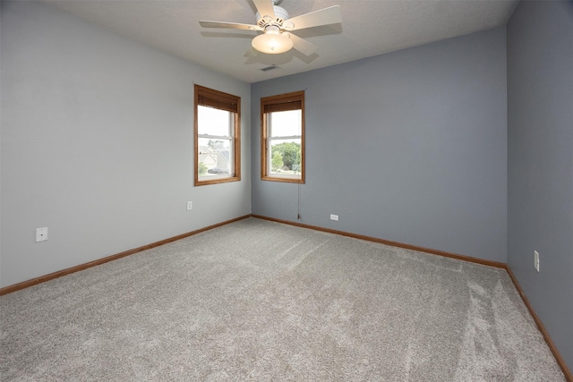 201 Elm Ave, Norwalk, IA 50211 - empty room with light colored carpet and ceiling fan