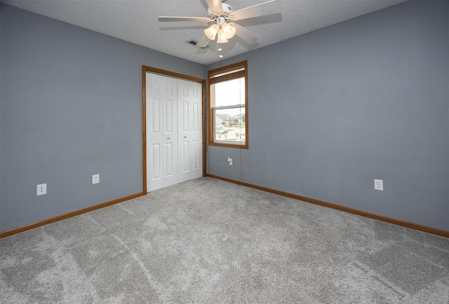 201 Elm Ave, Norwalk, IA 50211 - unfurnished bedroom with carpet, a closet, and ceiling fan