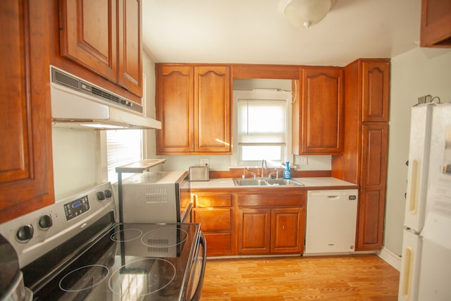 kitchen with sink, extractor fan, white appliances, and light hardwood / wood-style floors