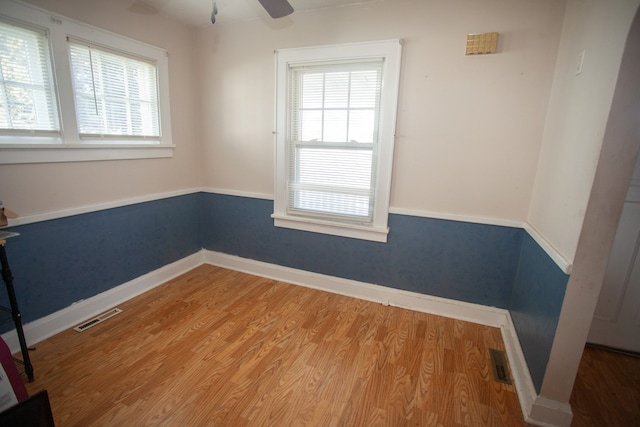 unfurnished room with hardwood / wood-style flooring and ceiling fan