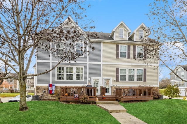 view of front of property featuring a deck, a front lawn, and central air condition unit