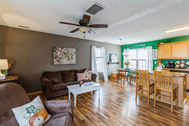 living room with hardwood / wood-style floors and ceiling fan