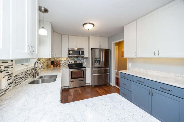 kitchen with stainless steel appliances, sink, and white cabinets