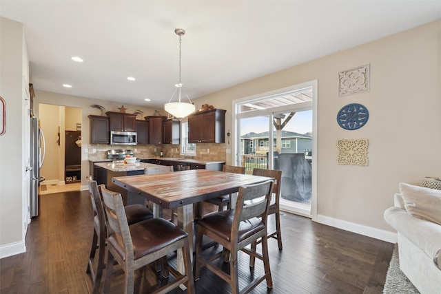 dining room featuring dark hardwood / wood-style flooring and sink