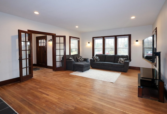 living room with light hardwood / wood-style flooring and french doors