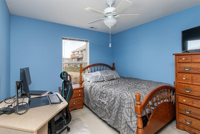 bedroom with light carpet, a textured ceiling, and ceiling fan