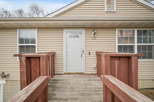 property entrance featuring a wooden deck