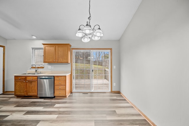 kitchen with light countertops, a sink, light wood-type flooring, dishwasher, and baseboards