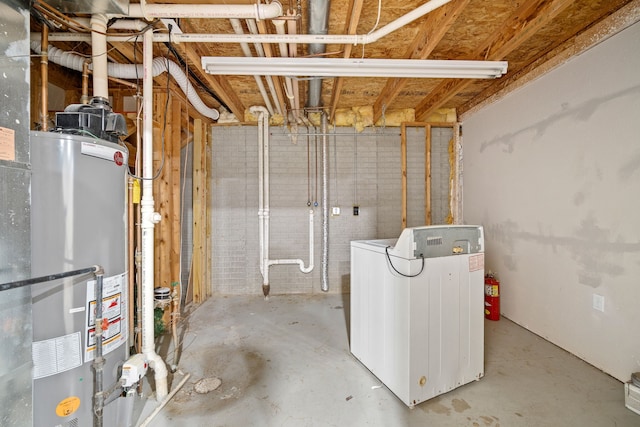 unfinished below grade area with washer / dryer and gas water heater