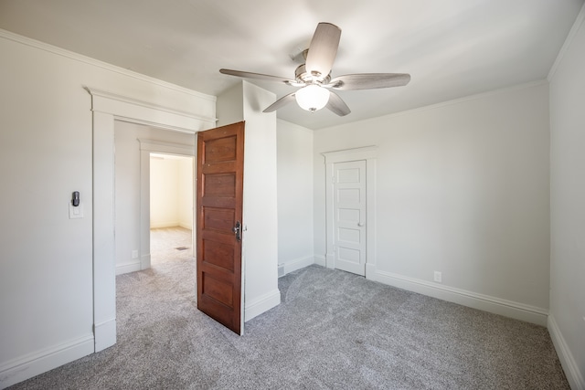 unfurnished bedroom with carpet flooring, a closet, ceiling fan, and crown molding