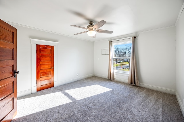 spare room with light carpet, ceiling fan, and crown molding