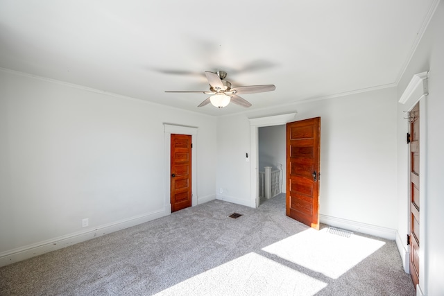 unfurnished bedroom featuring light carpet, ceiling fan, and crown molding