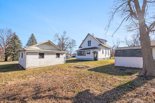 exterior space featuring a yard and an outbuilding