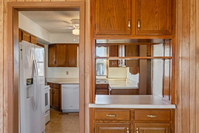 kitchen with a textured ceiling, ceiling fan, and white appliances