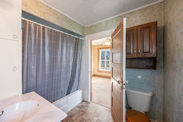 full bathroom featuring a textured ceiling, ceiling fan, shower / bath combo with shower curtain, sink, and toilet