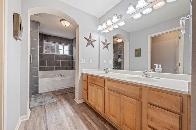 bathroom featuring shower with separate bathtub, vanity, and hardwood / wood-style flooring