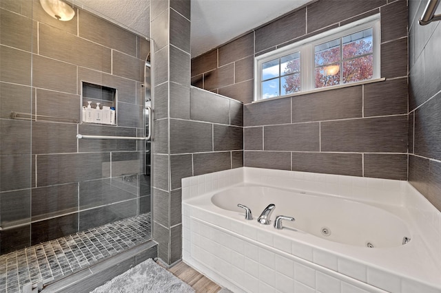 bathroom featuring hardwood / wood-style floors and plus walk in shower