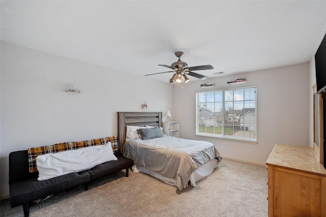 bedroom featuring ceiling fan and light carpet