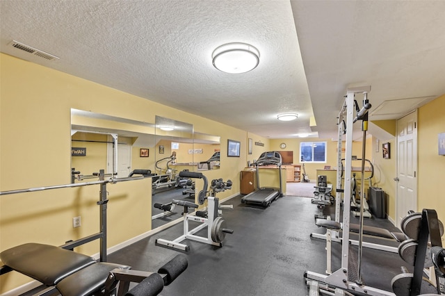 workout area with a textured ceiling