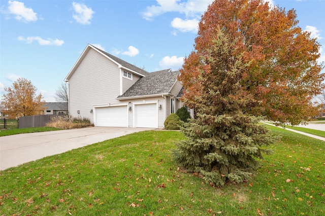 view of side of home with a garage and a yard