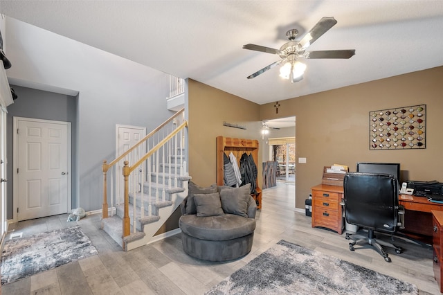 office featuring ceiling fan, light hardwood / wood-style floors, and a textured ceiling