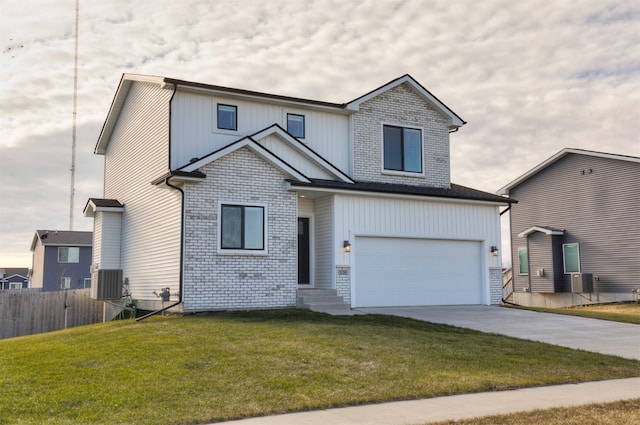 view of front of property featuring central AC unit, a garage, and a front lawn