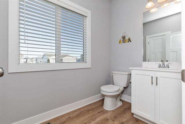 bathroom featuring hardwood / wood-style floors, vanity, and toilet